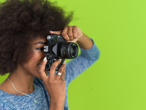 black girl taking photo on a retro camera