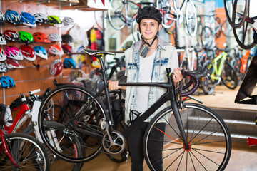 Obraz premium Teenage boy looking for new sport bike