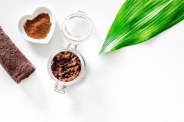 Spa treatment. Coffee scrub on white background top view copyspace
