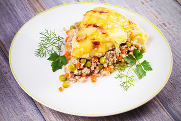 Traditional shepherd pie. Meat, potato, cheese, carrot, onion and green peas casserole