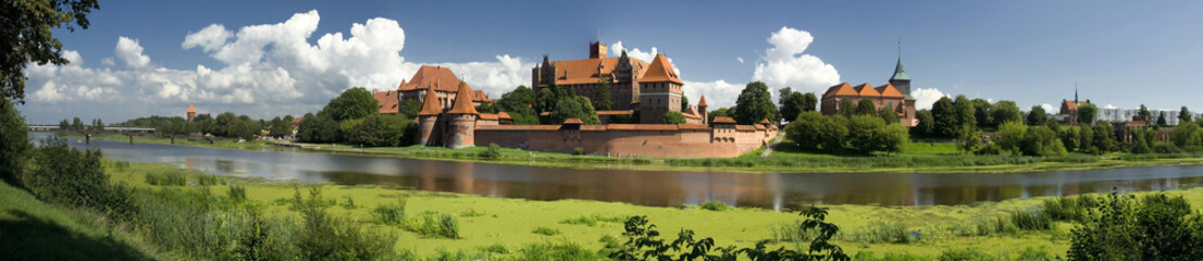 Naklejka na ściany i meble View across the river to the old fortress of the Teutonic Order in Malbork