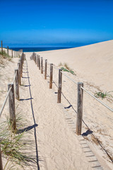 Wooden board path way to the sandy beach