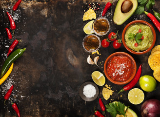 Fototapeta na wymiar Green Homemade Guacamole with Tortilla Chips, Salsa and tequila shots