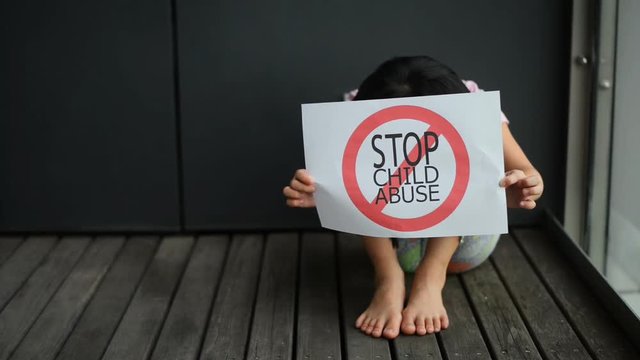 Young girl show child abuse sign.