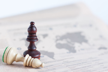 Chess figure on newspaper, business concept - strategy, leadership, team and success, man and woman...