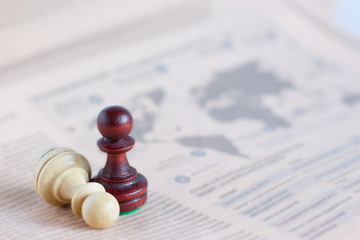 Chess figure on newspaper, business concept - strategy, leadership, team and success, man and woman...