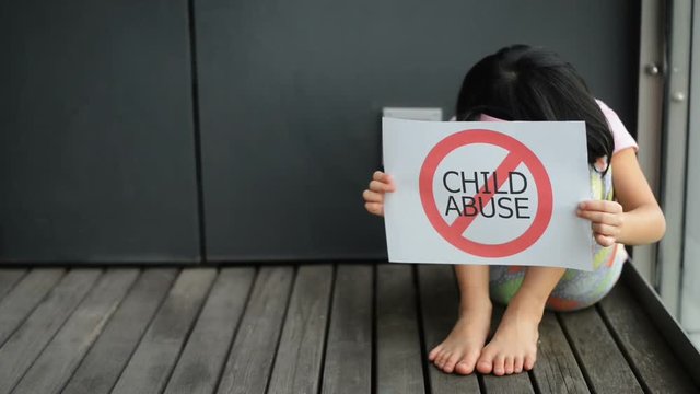 Young girl show child abuse sign.