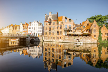 Fototapeta na wymiar Riverside view with beautiful old buildings and water channel during the morning light in Gent city, Belgium