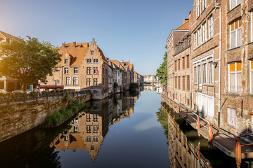 Fototapeta na wymiar Riverside view with beautiful old buildings and water channel during the morning light in Gent city, Belgium