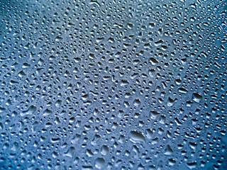 Water drops on blue glass