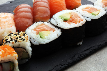 close up of sashimi sushi set with chopsticks and soy - sushi roll with salmon and sushi roll with smoked eel, selective focus.
