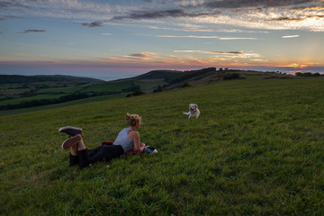 Fototapeta na wymiar female relaxing at sunset in a field