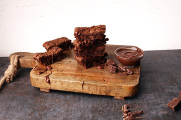 Brownie stack, chocolate cake on rustic wooden board