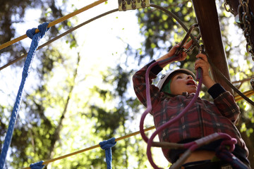Kid climbing in rope park