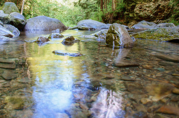 Large stones on a mountain river with clear blue water.Carpathians