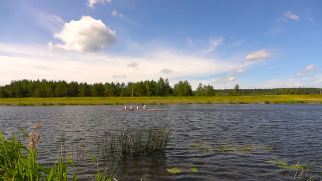 Training in rowing on the lake. Slow motion.