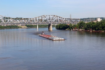 The barge headed up river on the boarders of Kentucky and Ohio.