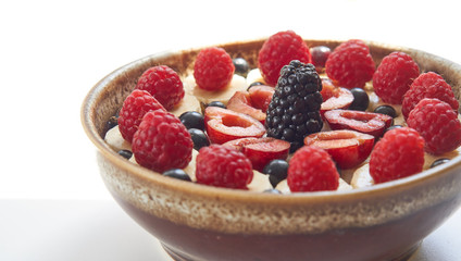 healthy breakfast oatmeal porridge with berries in ceramic bowl