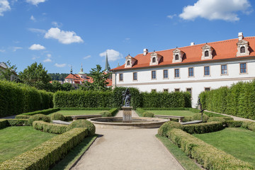 Fototapeta na wymiar Statue and building at the formal Wallenstein (Waldstein) Garden (Valdstejnska Zahrada)). It is a public Baroque garden at the Lesser Town (Mala Strana) in Prague, Czech Republic. 