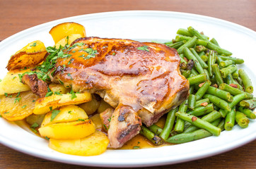 Baked pork chop with  roasted potatoes, green beans and gravy