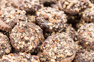 Crispy cookies with chocolate and hazelnuts as a background close up. Selective focus