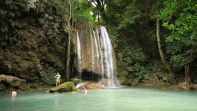 People traveling and bath in Erawan waterfall, Thailand