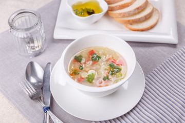 Fresh vegetable soup made of cabbage, carrot, potato, red bell pepper, tomato in bowl