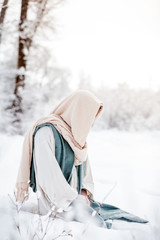 Jesus Christ kneels in the snow to pray