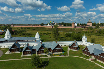 Fototapeta na wymiar Suzdal, Russia. Panorama with two largest Suzdal monasteries. The cells of the Pokrovsky monastery (foreground) and the Spaso-Evfimiev monastery (background).