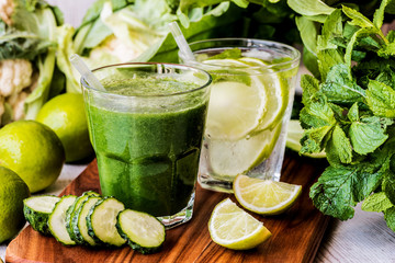 green smoothie and detox water with lime, mint and ice on wooden background. detox diet. Close-up