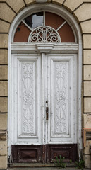 Old wooden, richly decorated white door