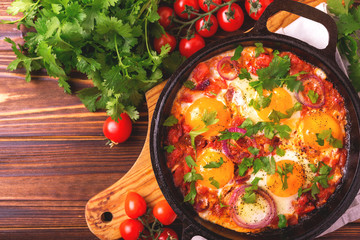 Shakshuka. Traditional Israeli cuisine. Fried eggs with vegetables