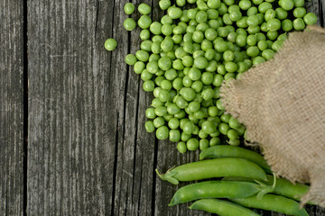 Green peas on a wooden table