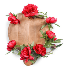 Composition of beautiful peonies and wooden board on white background