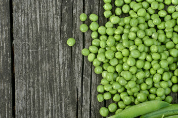 Green peas on a wooden table