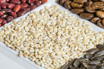 Pearl barley close-up in set of groceries. Food product background with limited depth of field.
