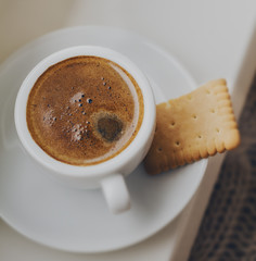 Tasty coffee espresso in small cup near window. Home concept. Top View. Toning.