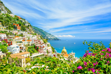 beautiful view on Positano on Amalfi coast with blurred flowers on foreground