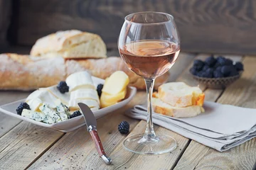  A glass of rose wine served with cheese plate, blackberries and baguette © svittlana