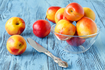 Fresh nectarines on blue wooden table