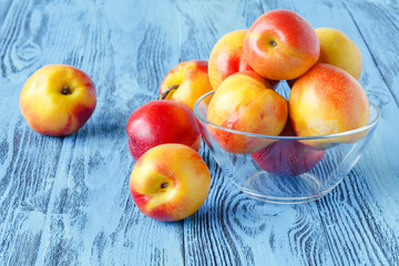 Fresh nectarines on blue wooden table