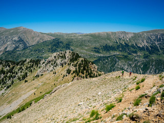 Fototapeta na wymiar Two hikers ascending mountain in Pyrenees