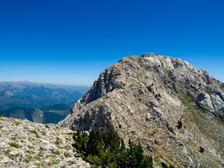 Tiny people figures climbing a mountain