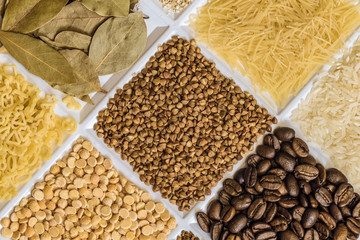 Buckwheat in set of groceries with bay leafs, vermicelli, rice, roasted coffee beans, dried peas, figured macaroni.