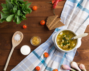Traditional Ukrainian green borscht with sorrel and eggs on the wooden background. Top view