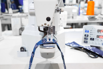 Sewing machine process a seam on jeans fabric