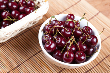 Ripe sweet cherry in a bowl on a napkin