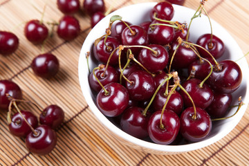Ripe sweet cherry in a bowl on a napkin