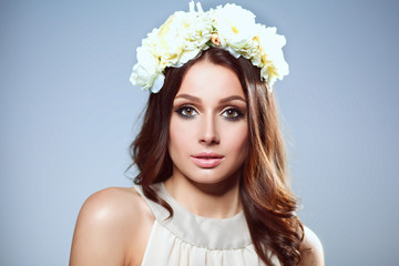 Portrait of a beautiful woman with flowers in her hair