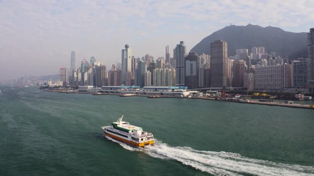 Hong Kong Aerial v183 Flying low along ferry in Victoria Harbour heading to terminal with cityscape views 2/17
